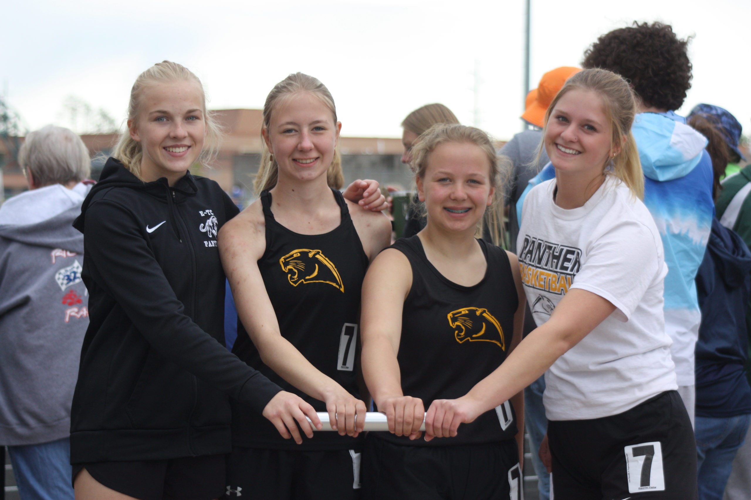 Runners holding a baton